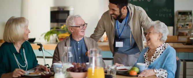 Seniors sharing breakfast and conversation in a supportive assisted care in Beaverton, OR.