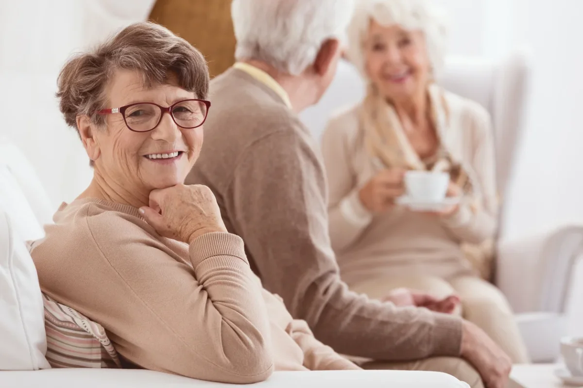Transition to Memory Care for a Happy Older Adult Happy elderly woman smiling, representing a supported transition to memory care or assisted living.